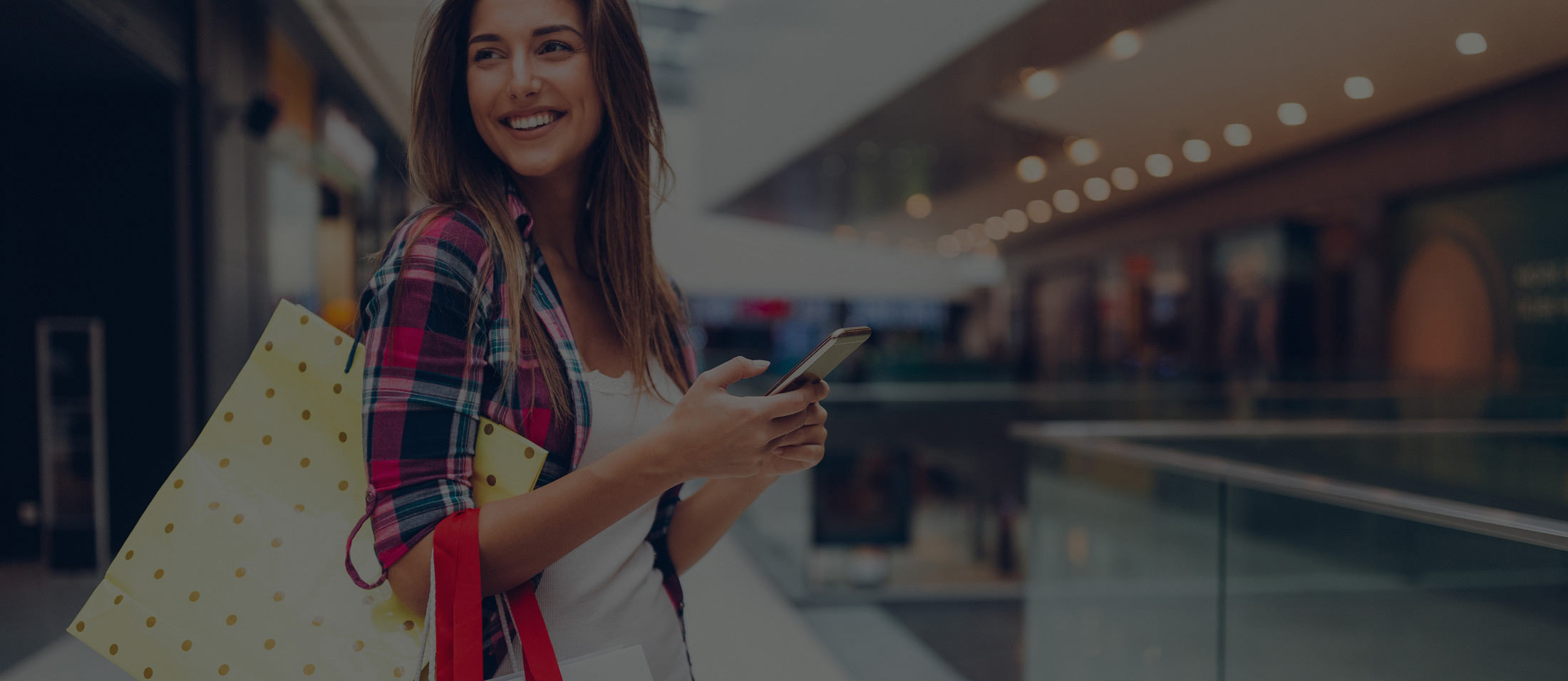 A girl smiling while using RemServ Wallet on her Smartphone. 